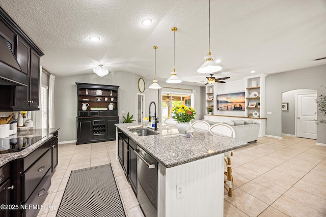 217 Willow Winds Pkwy, Saint Johns, FL 32259 - kitchen featuring a sink, stainless steel dishwasher, black electric stovetop, a kitchen bar, and arched walkways