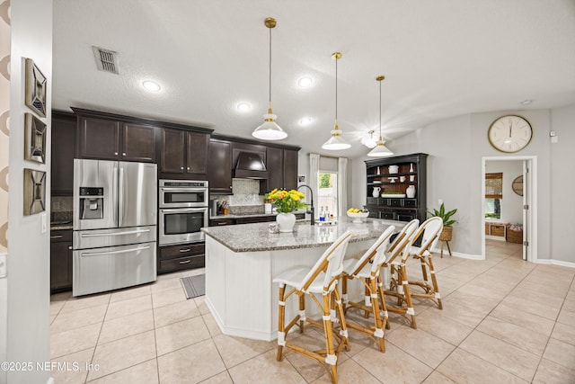 217 Willow Winds Pkwy, Saint Johns, FL 32259 - kitchen with stainless steel appliances, light tile patterned floors, premium range hood, light stone counters, and recessed lighting