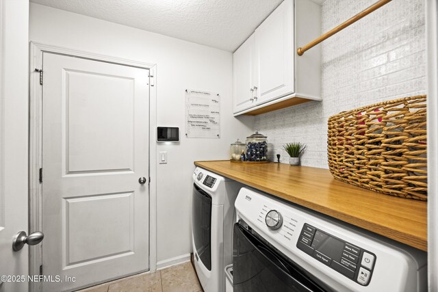 217 Willow Winds Pkwy, Saint Johns, FL 32259 - washroom with washing machine and dryer, cabinet space, light tile patterned floors, a textured ceiling, and baseboards