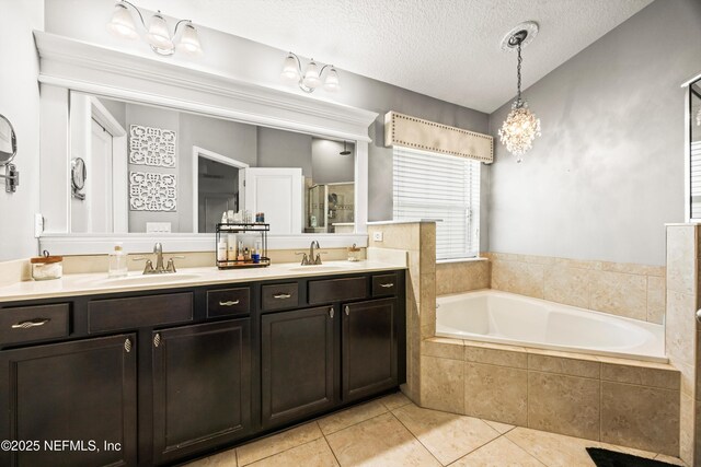 217 Willow Winds Pkwy, Saint Johns, FL 32259 - bathroom with double vanity, tile patterned floors, a bath, a stall shower, and a textured ceiling