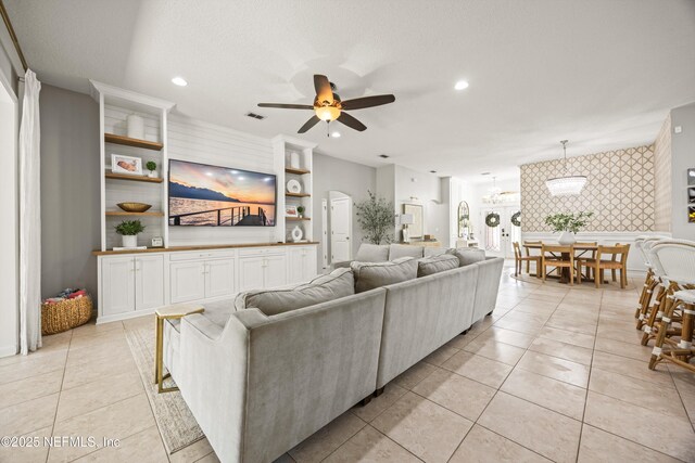 217 Willow Winds Pkwy, Saint Johns, FL 32259 - living room with a ceiling fan, a chandelier, light tile patterned floors, an accent wall, and recessed lighting