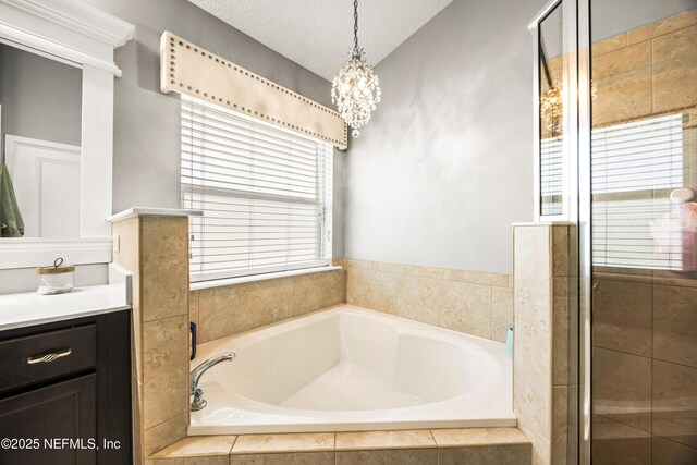 217 Willow Winds Pkwy, Saint Johns, FL 32259 - full bathroom featuring a garden tub, vanity, a shower stall, a chandelier, and a textured ceiling