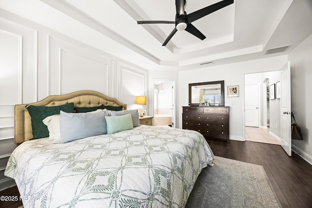 217 Willow Winds Pkwy, Saint Johns, FL 32259 - bedroom with a raised ceiling, wood finished floors, ceiling fan, ensuite bathroom, and baseboards