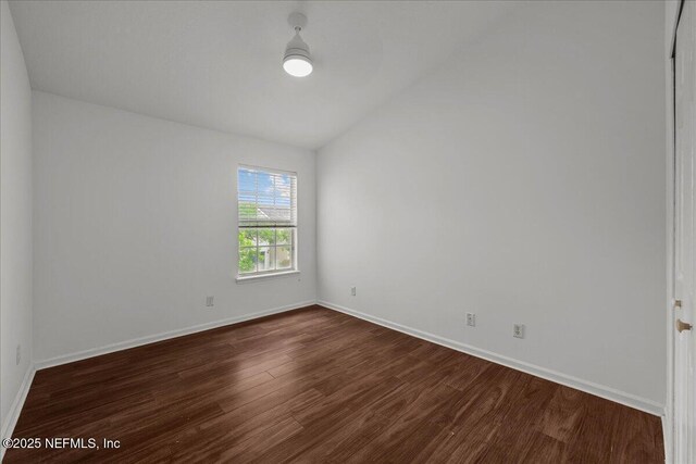 7990 Baymeadows Rd Unit 1305, Jacksonville, FL 32256 - unfurnished room featuring dark wood finished floors, vaulted ceiling, and baseboards