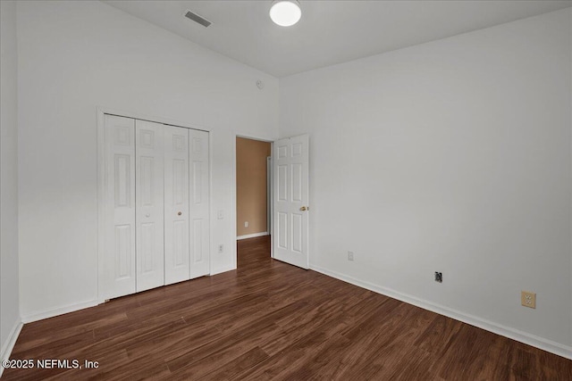 7990 Baymeadows Rd Unit 1305, Jacksonville, FL 32256 - unfurnished bedroom with wood finished floors, baseboards, and a closet