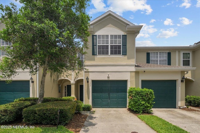 7990 Baymeadows Rd Unit 1305, Jacksonville, FL 32256 - view of front of house with stucco siding, concrete driveway, and an attached garage