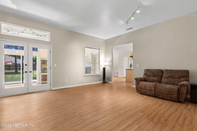 96131 River Marsh Bnd, Fernandina Beach, FL 32034 - living area featuring track lighting, light wood-style flooring, french doors, and baseboards