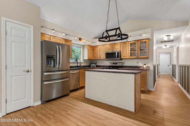 96131 River Marsh Bnd, Fernandina Beach, FL 32034 - kitchen with appliances with stainless steel finishes, lofted ceiling, light wood-type flooring, a center island, and glass insert cabinets