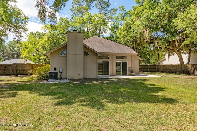 96131 River Marsh Bnd, Fernandina Beach, FL 32034 - back of house with a chimney, a patio area, and central air condition unit