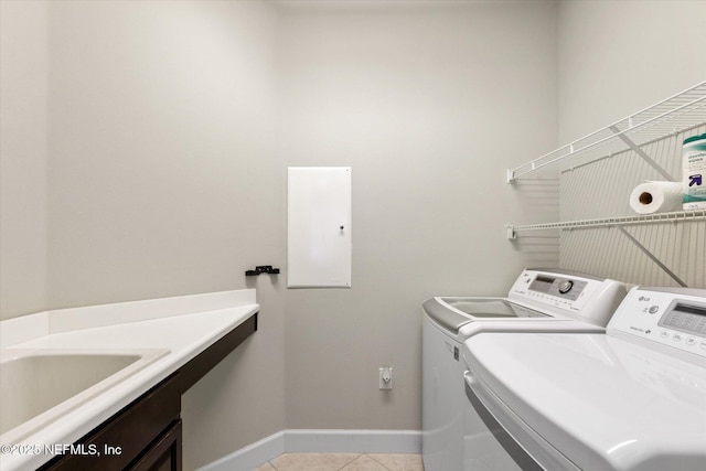 153 Hammocks Landing Dr, Ponte Vedra, FL 32081 - washroom featuring washing machine and clothes dryer, light tile patterned flooring, baseboards, and cabinet space