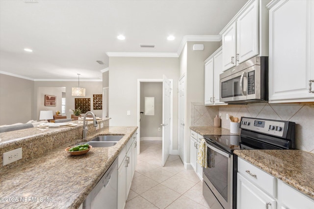 153 Hammocks Landing Dr, Ponte Vedra, FL 32081 - kitchen with appliances with stainless steel finishes, a sink, white cabinets, crown molding, and backsplash