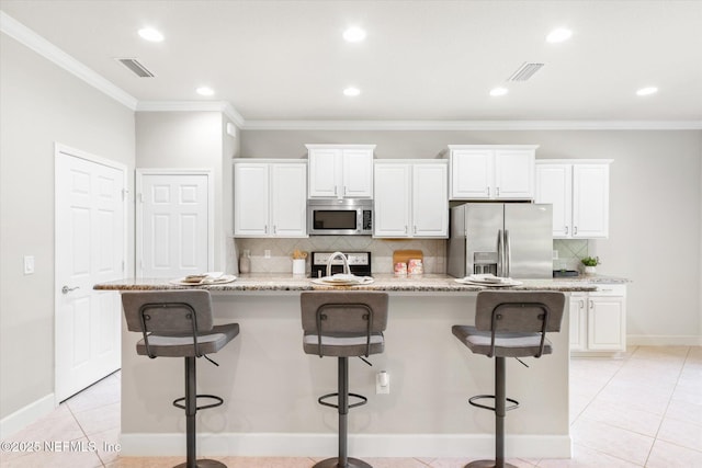 153 Hammocks Landing Dr, Ponte Vedra, FL 32081 - kitchen with appliances with stainless steel finishes, backsplash, ornamental molding, an island with sink, and white cabinets
