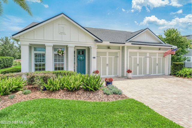 31 Port Ave, Saint Johns, FL 32259 - view of front facade with board and batten siding, driveway, a garage, and a shingled roof