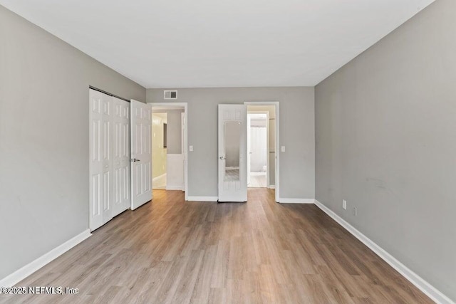 8849 Old Kings Rd S Unit 189, Jacksonville, FL 32257 - unfurnished bedroom with wood finished floors, baseboards, and a closet
