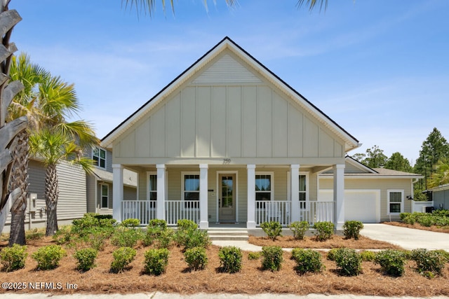 250 Ponder Cir, Yulee, FL 32097 - view of front facade with board and batten siding, covered porch, an attached garage, and driveway