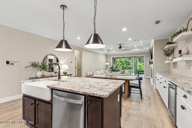 250 Ponder Cir, Yulee, FL 32097 - kitchen featuring stainless steel dishwasher, light wood finished floors, open shelves, a sink, and dark brown cabinets