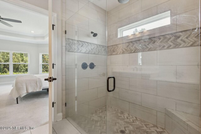 250 Ponder Cir, Yulee, FL 32097 - ensuite bathroom featuring a stall shower, ceiling fan, and a tray ceiling
