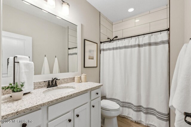 250 Ponder Cir, Yulee, FL 32097 - full bathroom featuring toilet, vanity, a shower with curtain, and wood finished floors