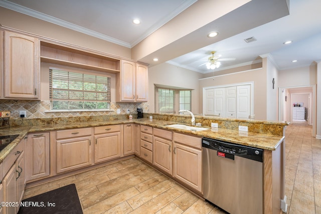 kitchen featuring dishwasher, light brown cabinetry, a peninsula, a sink, and tasteful backsplash