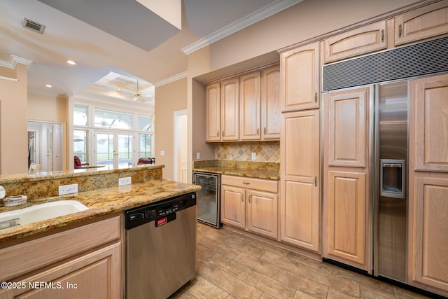 kitchen featuring stainless steel dishwasher, paneled built in refrigerator, wine cooler, light brown cabinets, and crown molding