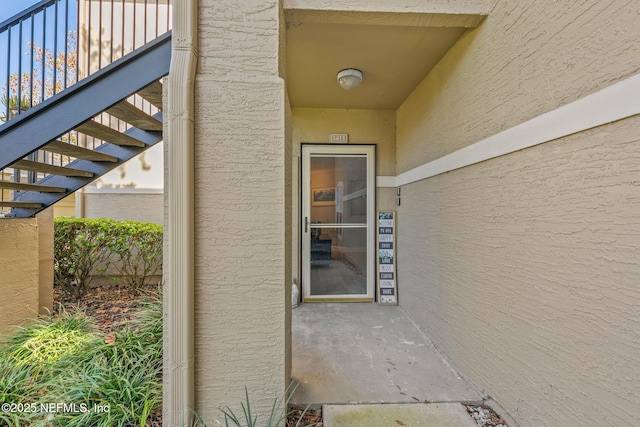 1701 The Greens Way Unit 1411, Jacksonville Beach, FL 32250 - property entrance with stucco siding