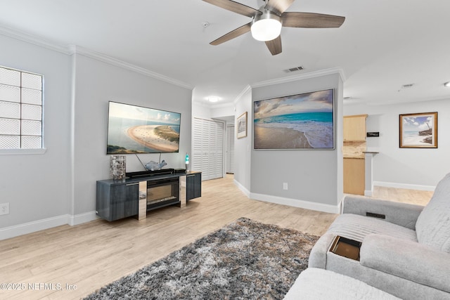 1701 The Greens Way Unit 1411, Jacksonville Beach, FL 32250 - living room featuring ornamental molding, wood finished floors, a ceiling fan, and baseboards
