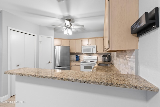 1701 The Greens Way Unit 1411, Jacksonville Beach, FL 32250 - kitchen with white appliances, a sink, decorative backsplash, ceiling fan, and light brown cabinetry