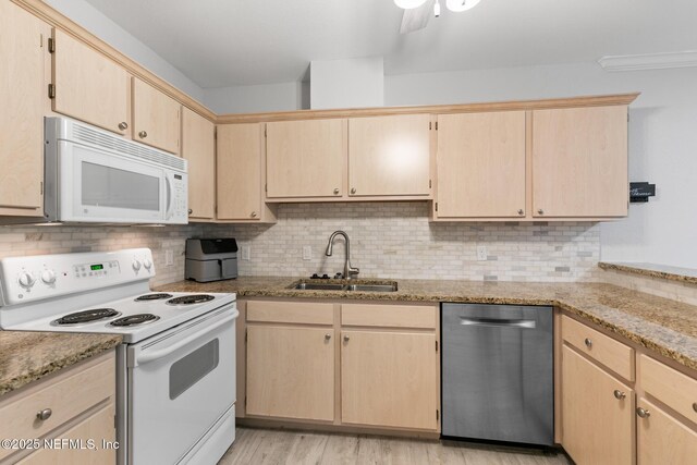1701 The Greens Way Unit 1411, Jacksonville Beach, FL 32250 - kitchen featuring white appliances, a sink, light brown cabinetry, tasteful backsplash, and light stone counters