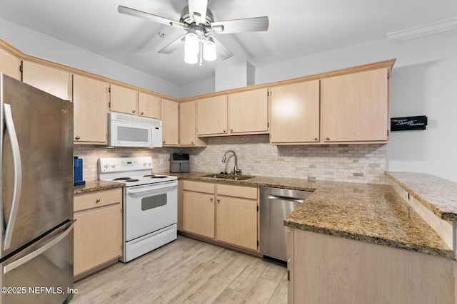 1701 The Greens Way Unit 1411, Jacksonville Beach, FL 32250 - kitchen featuring appliances with stainless steel finishes, a sink, light brown cabinets, and backsplash