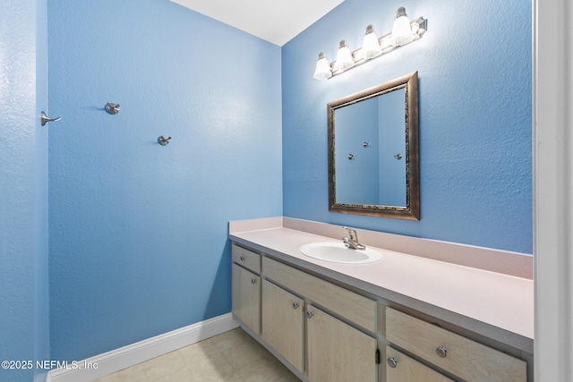 1701 The Greens Way Unit 1411, Jacksonville Beach, FL 32250 - bathroom featuring vanity, baseboards, and tile patterned floors