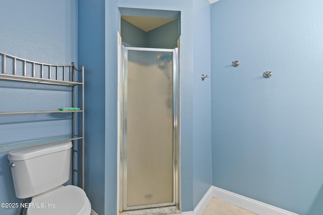 1701 The Greens Way Unit 1411, Jacksonville Beach, FL 32250 - bathroom with a shower stall, toilet, and baseboards