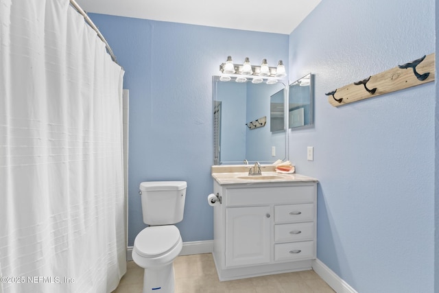 1701 The Greens Way Unit 1411, Jacksonville Beach, FL 32250 - bathroom featuring toilet, vanity, baseboards, tile patterned floors, and a shower with curtain