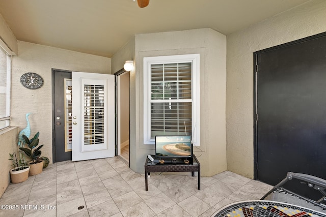 1701 The Greens Way Unit 1411, Jacksonville Beach, FL 32250 - doorway to property with stucco siding