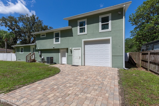 1823 Mauva Juan Ave, Jacksonville, FL 32225 - view of front of home featuring stucco siding, cooling unit, a garage, and decorative driveway