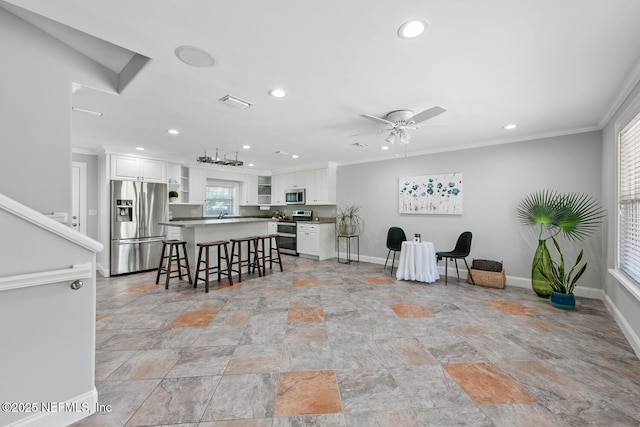 1823 Mauva Juan Ave, Jacksonville, FL 32225 - kitchen featuring stainless steel appliances, crown molding, white cabinets, light stone finish flooring, and recessed lighting
