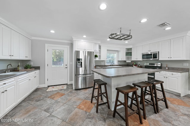 1823 Mauva Juan Ave, Jacksonville, FL 32225 - kitchen with appliances with stainless steel finishes, a sink, open shelves, crown molding, and light stone finish floors