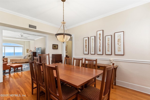 1846 Margaret St Unit 7C, Jacksonville, FL 32204 - dining space featuring light wood-style floors, ornamental molding, ceiling fan, and baseboards