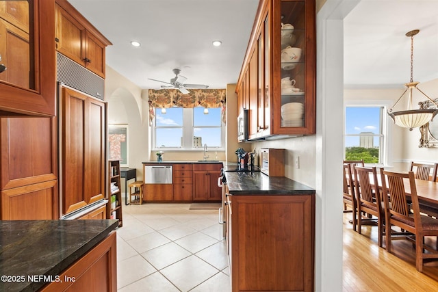 1846 Margaret St Unit 7C, Jacksonville, FL 32204 - kitchen with brown cabinets, healthy amount of natural light, a ceiling fan, arched walkways, and recessed lighting