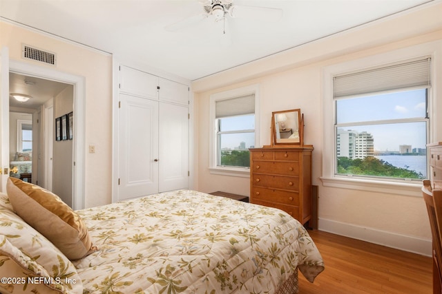 1846 Margaret St Unit 7C, Jacksonville, FL 32204 - bedroom with light wood-style floors, baseboards, a closet, and multiple windows