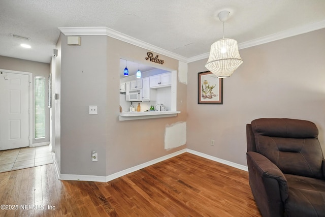 705 Marsh Cove Pl, Ponte Vedra Beach, FL 32082 - sitting room with baseboards, wood finished floors, and ornamental molding