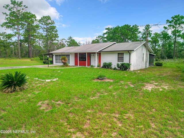 23063 SW Edgewater Blvd, Dunnellon, FL 34431 - ranch-style house with concrete driveway, a front lawn, and stucco siding