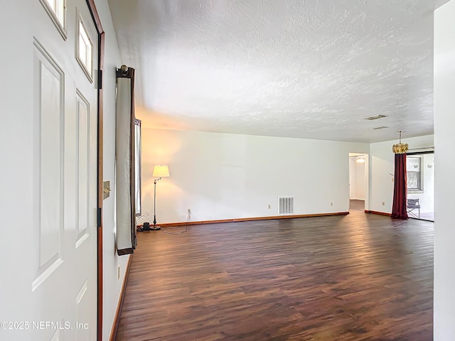 23063 SW Edgewater Blvd, Dunnellon, FL 34431 - unfurnished room featuring dark wood finished floors, baseboards, and a textured ceiling