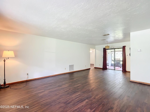 23063 SW Edgewater Blvd, Dunnellon, FL 34431 - unfurnished living room with wood finished floors, baseboards, and a textured ceiling
