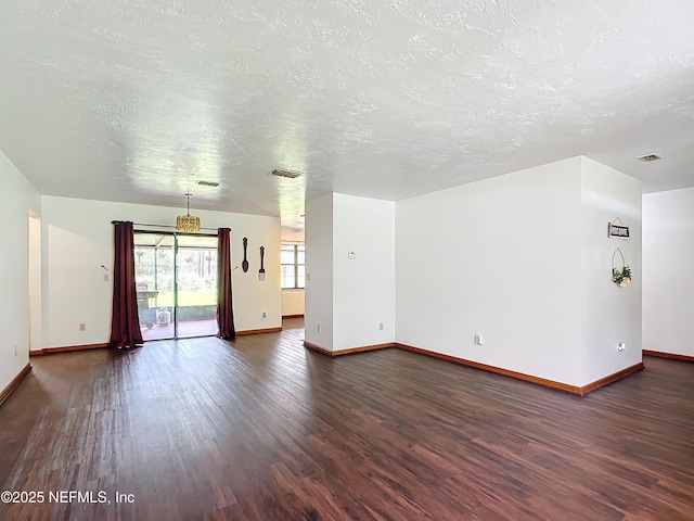 23063 SW Edgewater Blvd, Dunnellon, FL 34431 - unfurnished living room featuring dark wood-style flooring, baseboards, and a textured ceiling
