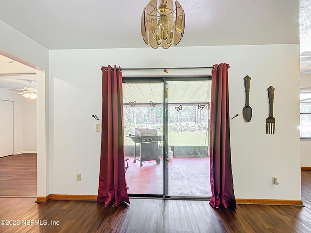 23063 SW Edgewater Blvd, Dunnellon, FL 34431 - doorway with a chandelier, wood finished floors, baseboards, and a ceiling fan