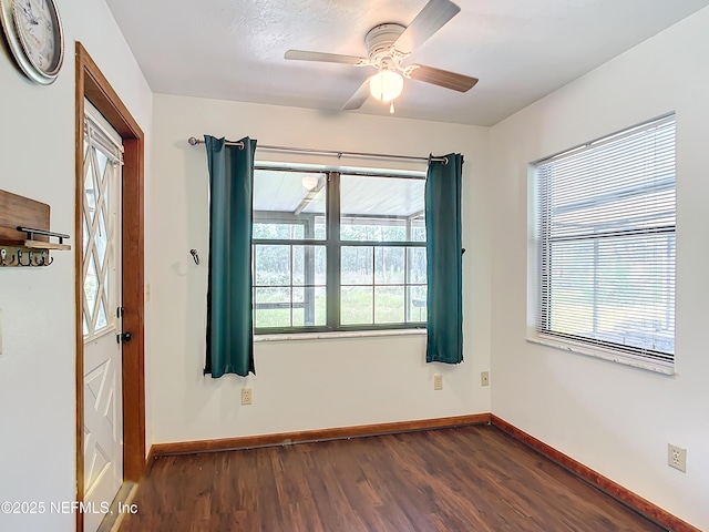 23063 SW Edgewater Blvd, Dunnellon, FL 34431 - empty room featuring dark wood finished floors, baseboards, and a ceiling fan