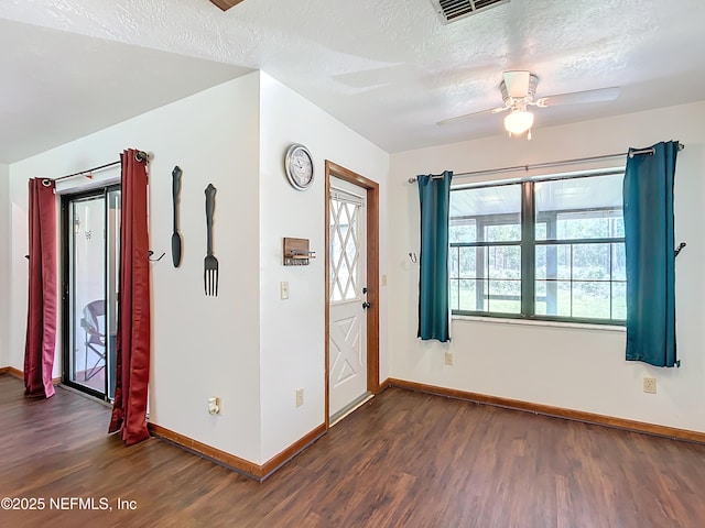 23063 SW Edgewater Blvd, Dunnellon, FL 34431 - entryway with dark wood-style flooring, baseboards, a ceiling fan, and a textured ceiling
