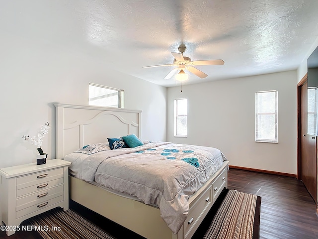 23063 SW Edgewater Blvd, Dunnellon, FL 34431 - bedroom with dark wood-style flooring, baseboards, a textured ceiling, and ceiling fan