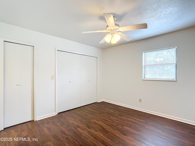 23063 SW Edgewater Blvd, Dunnellon, FL 34431 - unfurnished bedroom with dark wood-type flooring, baseboards, and a ceiling fan