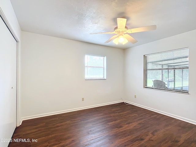 23063 SW Edgewater Blvd, Dunnellon, FL 34431 - unfurnished bedroom featuring dark wood-type flooring, a closet, and baseboards